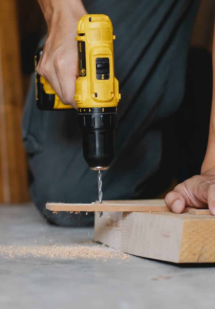 Hands drilling wood