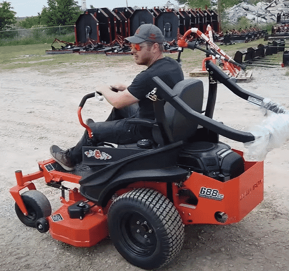 man riding a bad boy mower