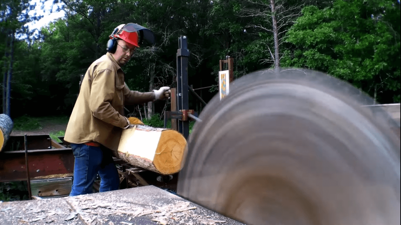man operating a saw mill