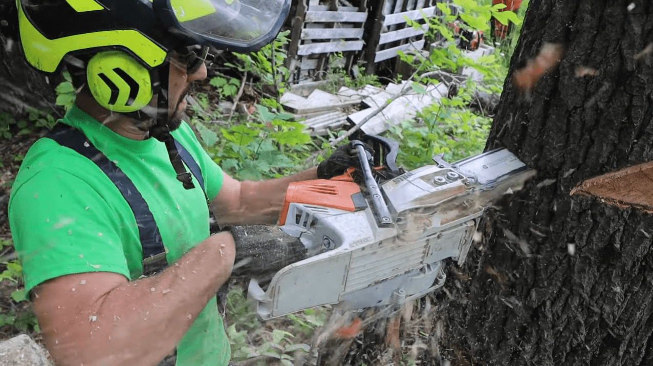 person operating a chainsaw