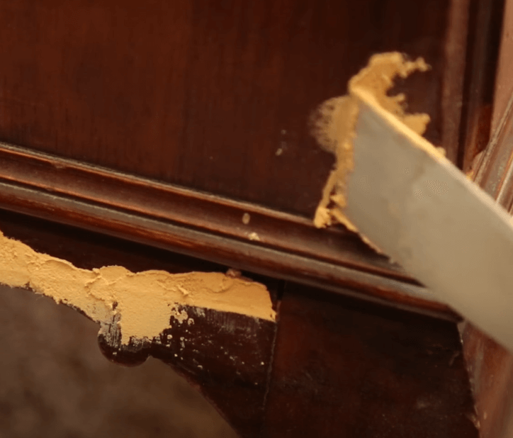 applying wood filler to gaps