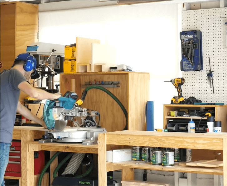 person operating a 12 inch miter saw