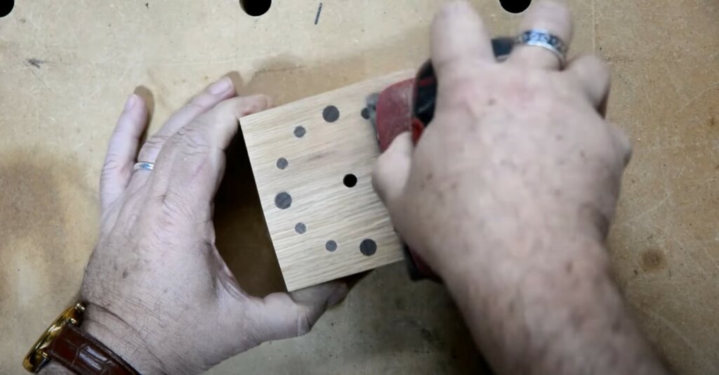 Sanding all sides of the glued clock body