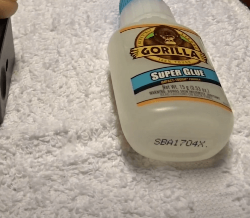 Gorilla Super Glue on white cloth