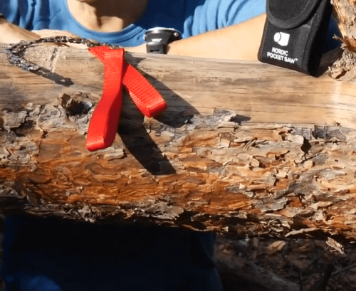 Nordic 25-Inch Pocket Chainsaw on a log