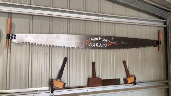 antique crosscut saw on a wall