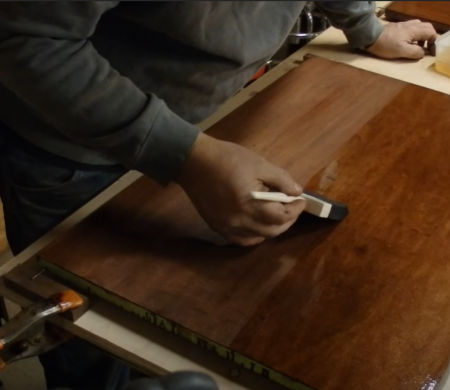 applying Oil Based Polyurethane on a wooden board