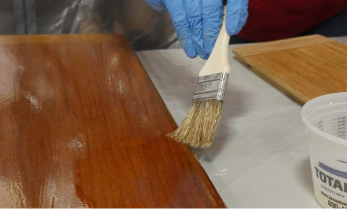 applying TotalBoat Clear Penetrating Epoxy Wood Sealer Stabilizer to wooden board