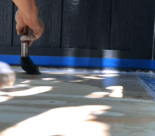 applying liquid latex on plywood deck
