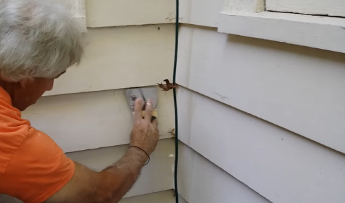 applying spackle paste to wall