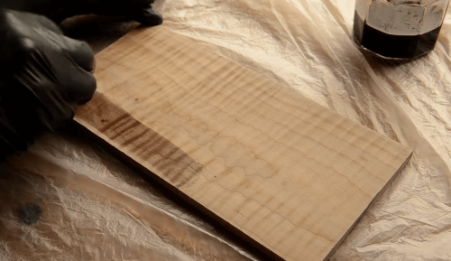 applying stain on maple wood