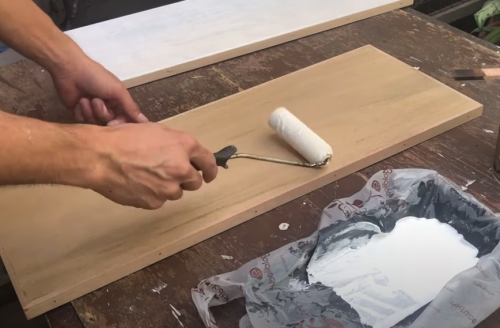 applying wood primer on plywood