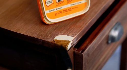 applying wood spackle to drawer corner