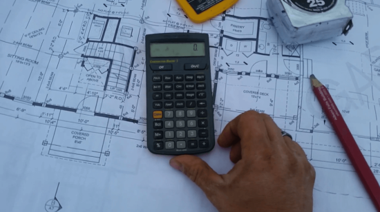 calculator and construction blueprint
