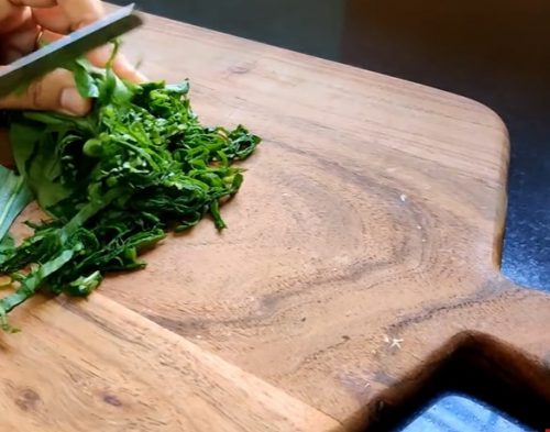 cutting vegetables on chopping board