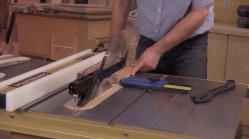 cutting wooden board with table saw