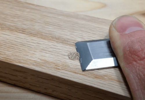 cutting wooden dowel using chisel
