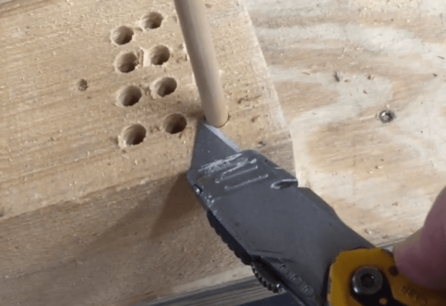 cutting wooden dowels using blade