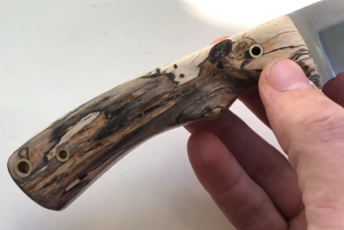 holding a wood knife handle