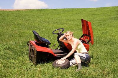 Woman struggling with her faulty_mower