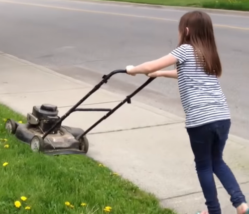 little girl mowing the lawn