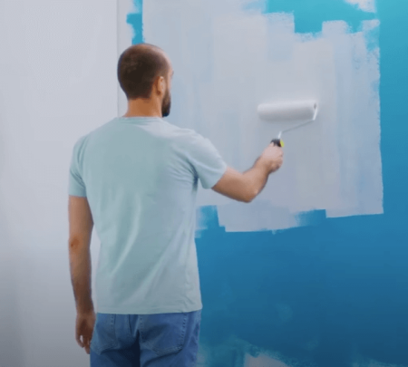 man painting a wall