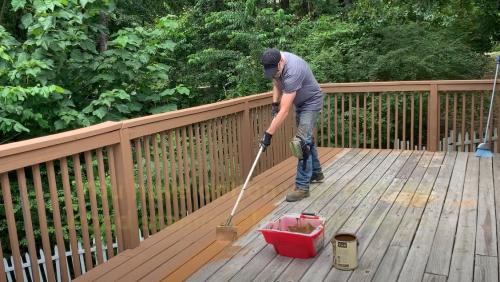 man staining deck with Deck Stain Brush Applicator