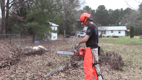 man wearing chainsaw protective gear