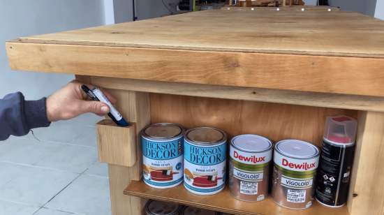 organizing wood stain cans on a workbench