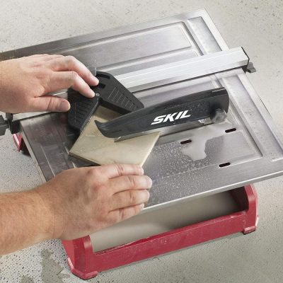 person cutting wet tile with SKIL 3540-02
