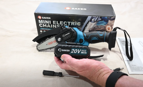 person holding the battery of Saker Mini Chainsaw