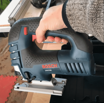 person operating Bosch JS470E Corded Top-Handle Jigsaw