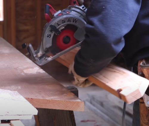 person operating a Skil saw