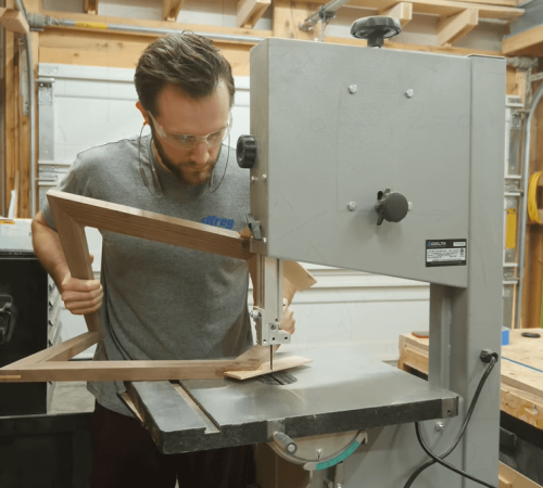 person operating a bandsaw