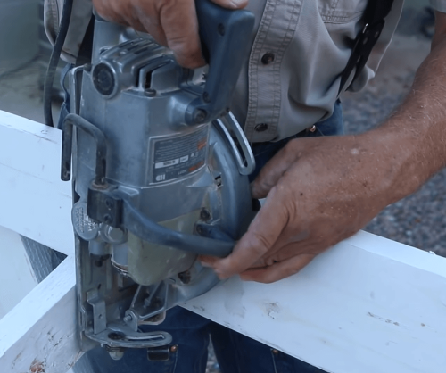 person operating a worm drive saw