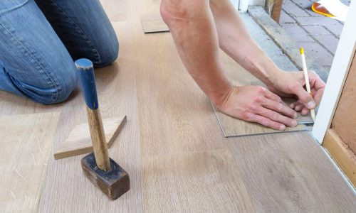 person replacing tile floor