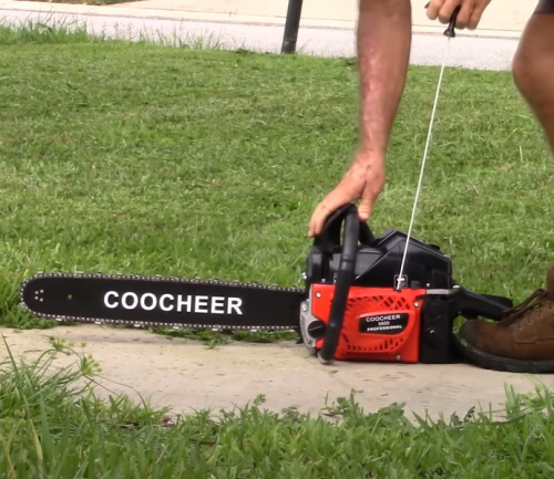 person starting a Coocheer Chainsaw 62CC 20-inch Gas Powered Chainsaw
