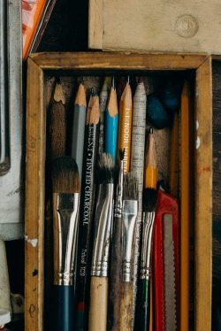 pencils and brushes in a wooden box