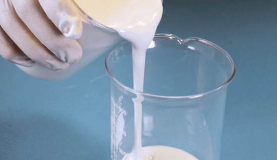pouring epoxy from a beaker