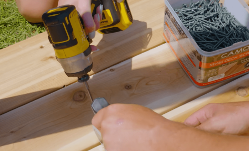power drill and wooden boards