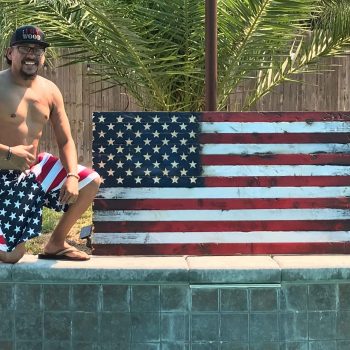rolando corral with united states wooden flag