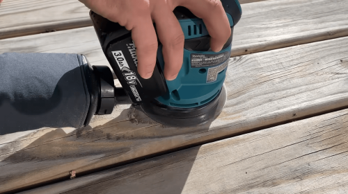 sanding off excess wooden surface