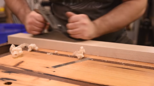 sanding wood with hand plane