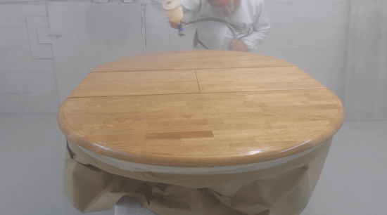spraying lacquer to dining table