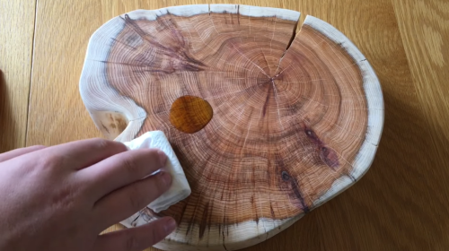 spreading oil on red oak cutting board