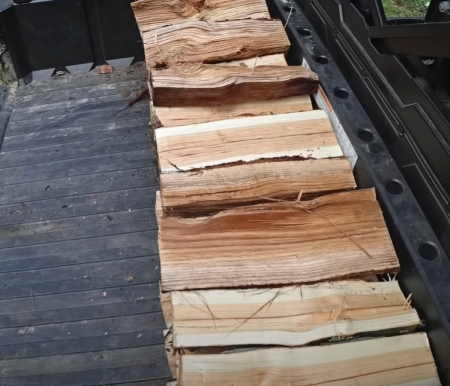 stacking cord of wood in a truck