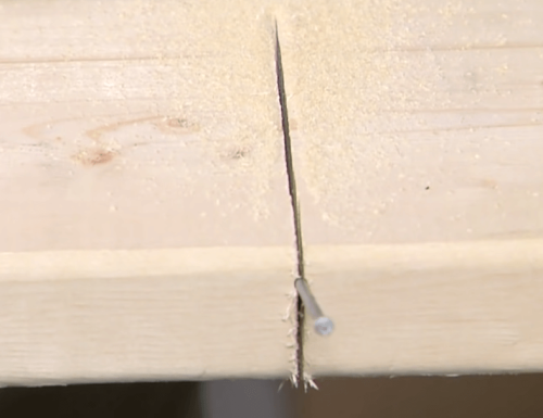 sticking nail on wood