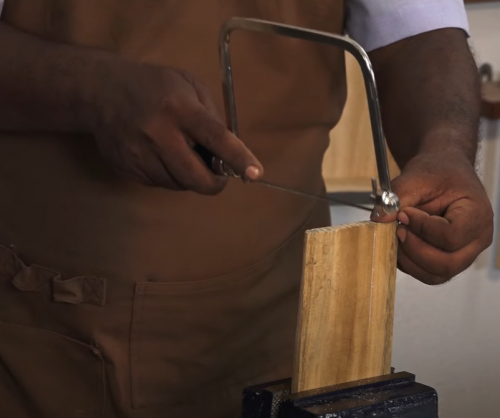 using a Robert Larson Coping Saw to cut wood