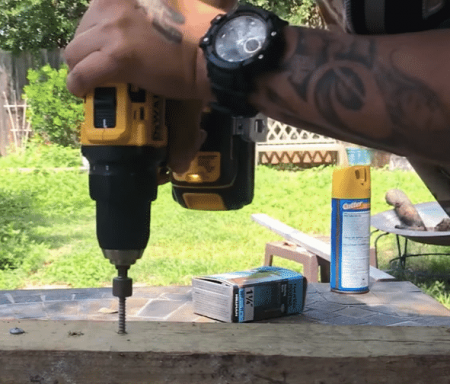 using a brushless drill on a block of wood
