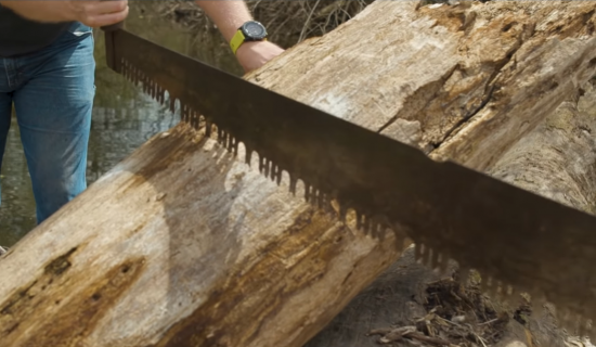 using a two person saw to cut lumber